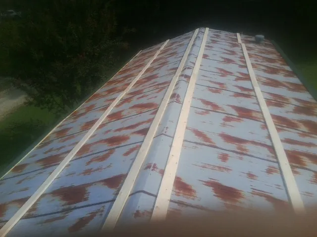 Rusted metal roof panels with new wood purlins before replacement — Storm Damage Roof Repair in Silverstreet by Roofing Brothers