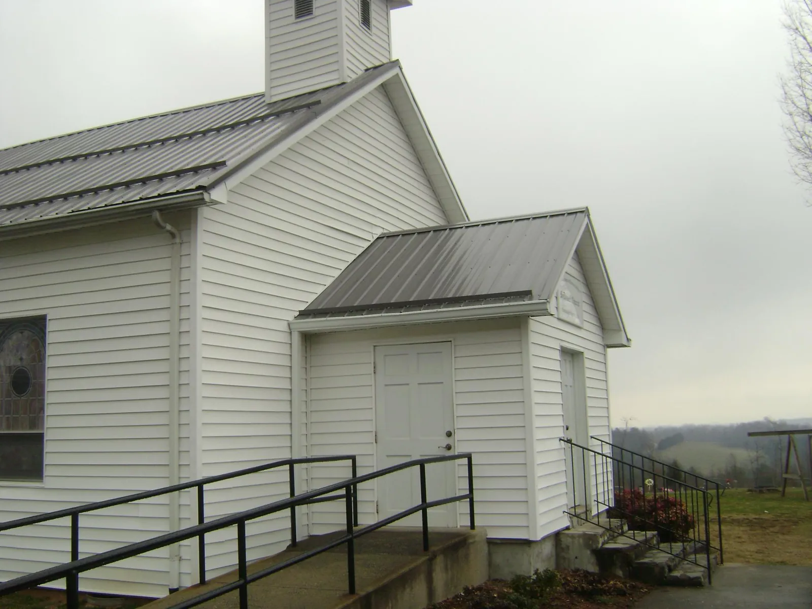 Gray metal roof on a white clapboard church with a steeple in Silverstreet